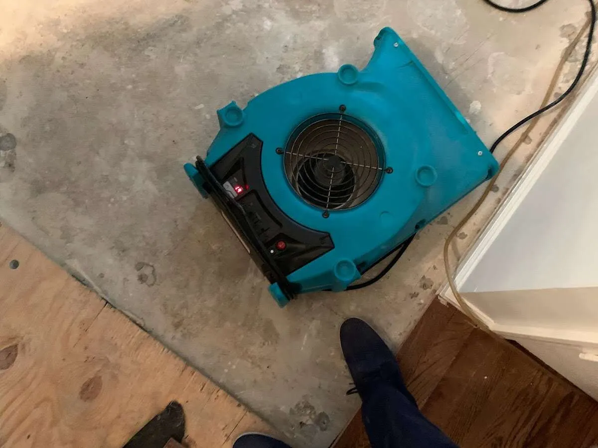 Air mover drying subfloor during Leak Detection & Repair in Morrow